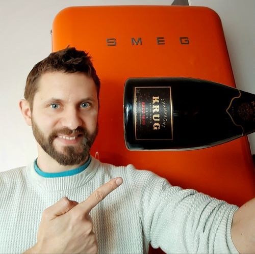 Photo of Jack Tovey holding a bottle of wine